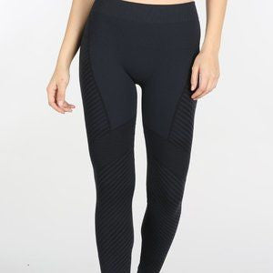 A pair of dark navy Nikibiki moto lined women's leggings with a bold patterned design.